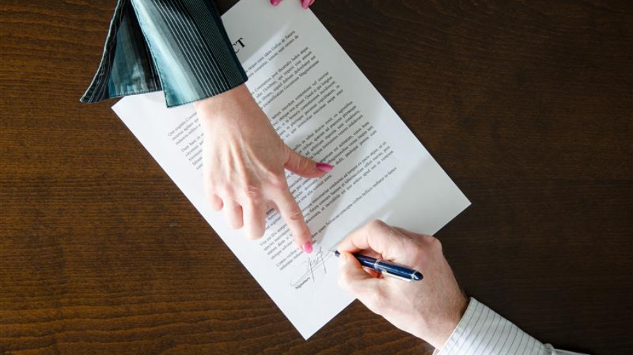 A business owner reviewing a complex document, highlighting the risks of mis-sold telecoms contracts and hidden fees.
